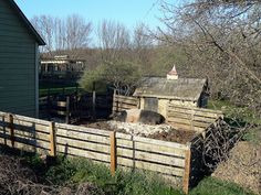 an old farm yard with a barn in the background