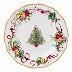 a white plate with a christmas tree on the front and red ribbon around it,