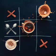 four cups of coffee with spoons and sugar on the side, arranged in a grid