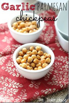 two white bowls filled with chickpeas sitting on top of a red table cloth