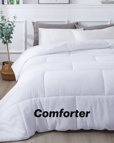 a comforter with the word comforter written on it and a potted plant next to it