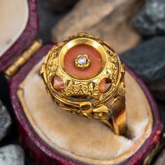 This vintage coral ring features a dome that encases a coral gem that is centered with a rose cut diamond. The coral has some movement inside the dome by design. The ring is crafted of 10k yellow gold and shows a lovely unpolished patina. Heirloom Oval Dome Ring With Rose Cut Diamonds, Heirloom Style Domed Ring For Formal Occasions, Heirloom Dome Ring With Rose Cut Diamonds, Gemstone Dome Ring For Wedding, Anniversary Gemstone Dome Ring, Vintage Domed Dome Ring As Gift, Vintage Domed Ring For Gift, Vintage Domed Ring As A Gift, Vintage Dome Ring As A Gift