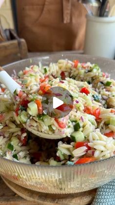 a bowl filled with pasta and vegetables on top of a table