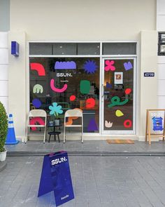 a store front that has been decorated with colorful art