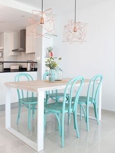 a table and chairs in a room with white walls