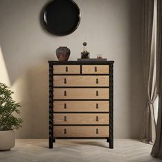 a wooden dresser sitting next to a potted plant