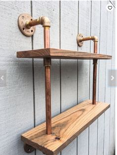 a wooden shelf with two faucets mounted to it's sides on the side of a building