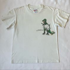 Good Used Condition Vintage Cayman Islands T-Shirt- Single Stitch All Hg Items Arrive Ready 2 Wear! [Jewelry/Leathers: Conditioned + Polished Clothing: Washed + Steamed *Unless Dry Cleaning Only Or Never Worn, Tags Attached Specified*] Will Consider Reasonable Offers! Questions Are Welcome Please Ask For Measurements- I'm Happy 2 Help! Casual Dinosaur Print Tops For Streetwear, Short Sleeve White Tops With Dinosaur Print, White Short Sleeve Tops With Dinosaur Print, White Short Sleeve Top With Dinosaur Print, Cotton Dinosaur Print Tops For Streetwear, Unisex White Top With Dinosaur Print, Vintage Faded T-shirt With Screen Print, Cheap Vintage Washed T-shirt, Dinosaur Shirt Vintage