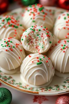 white chocolate truffles with sprinkles on a plate next to green and red ornaments