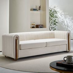 a white couch sitting on top of a rug in a living room