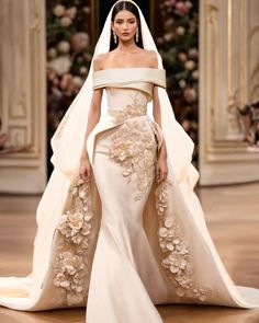 a woman in a wedding dress with flowers on it