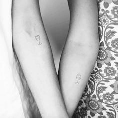 two people with matching tattoos on their arms