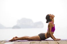 a woman is doing yoga on the dock