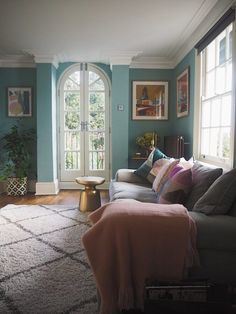 a living room filled with furniture and lots of windows