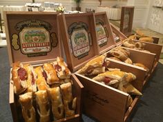 several wooden boxes filled with pastries on top of a table