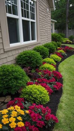 colorful flowers line the side of a house