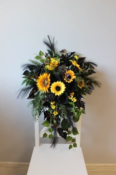 a bouquet of sunflowers and other flowers on a chair