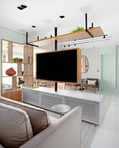 a large flat screen tv mounted to the side of a wall in a living room