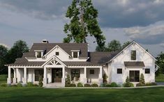 a large white house sitting on top of a lush green field