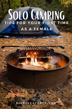 a campfire with the words solo camping tips for your first time as a female