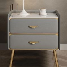 a table with two drawers and a lamp on top