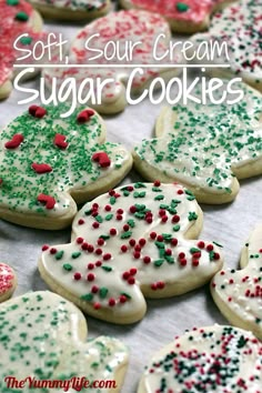 soft, sour cream sugar cookies decorated with sprinkles and christmas tree shapes