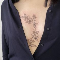 a woman with a flower tattoo on her chest