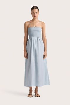 A feminine midi dress with a fitted, shirred bodice, gathered A-line skirt and thin adjustable straps. A similar silhouette to the Geriba Spaghetti Strap Dress, it is cut from 100% organic cotton in Sky Blue. Falling just above the ankle, style with a simple sandal for an elevated everyday. Maxi Blue Dresses, Sky Blue Maxi Dress, Simple Sandals, Maxi Dress Sale, Vintage Wardrobe, Blue Maxi, Spaghetti Strap Dress, Faithfull The Brand, Maxi Dress Blue