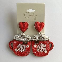 a pair of red and white beaded cup earrings