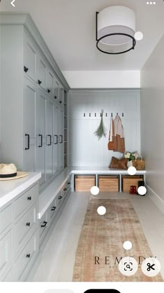 an image of a hallway with white cabinets and drawers on the wall, and a light fixture hanging from the ceiling