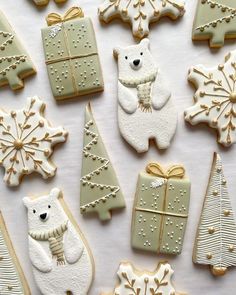 some cookies are decorated with white icing and christmas decorations on top of each other