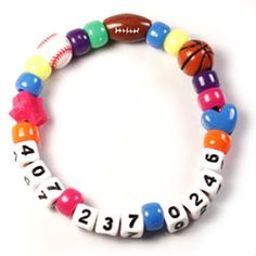 a colorful bracelet with basketballs and numbers is shown on a white surface, the beads are multicolored