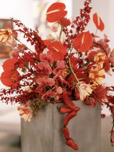 a vase filled with red and yellow flowers