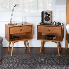 two wooden nightstands with speakers on them