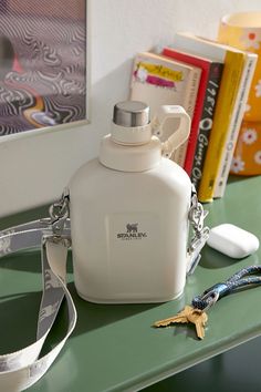 a white flask bottle sitting on top of a green table