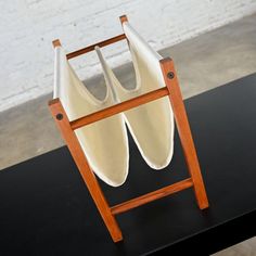 two white vases sitting on top of a black table