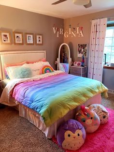 a room with a bed, pillows and other items on the floor in front of a window