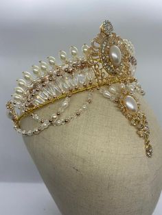 Professional ballet headpiece for the role of Gamzatti, in the ballet "La Bayadere", This impressive, hand made tiara features a golden frame, pearls in different shapes and sizes, as well as a dramatic big pearl drop. Absolutely stunning! Delivery time: 10 to 15 days $ 320 Elegant Ceremonial Crown Headpieces, Wedding Teardrop Crown Headpiece, Elegant Ceremonial Headpiece With Pinched Crown, Regal Crown Headpiece For Wedding, Regal Structured Crown Headpiece For Wedding, Regal Structured Crown Wedding Headpiece, Regal Tall Crown Headpieces For Wedding, Regal Wedding Headpiece With Structured Crown, Gold Regal Headpiece With Tall Crown