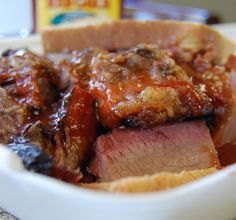 a close up of a plate of food with meat and sauce on the side,