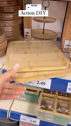 a person is pointing at some wooden trays