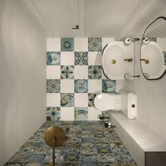 a bathroom with blue and white tiles on the walls