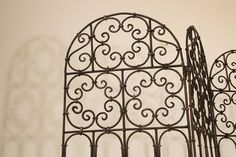 Hand forged folding Moroccan iron screen with three panels decorated with Moorish designs. Classic and elegant Art & Craft this highly embellished, detailed folding screen divider in the Mediterranean Spanish style iron art work would embellish any room, garden or wall, Santa Barbara style. Could make an amazing headboard. Three panels folding iron screen with Moorish designs in repeat. Heavy and well-made original condition. Each panel: 68.5" high, 15.75" wide Folds up for easy storage. Hand forged heavy wrought iron screen divider by skilled Moroccan artisans in Marrakech Morocco. Rustic Spanish colonial style wrought iron window grill or garden gate. Beautifully constructed with decorative scrolled circles. 0.50 inch thick border makes it strong enough to mount as a gate or just as an a Wrought Iron Window Grill, Wrought Iron Window, Iron Window Grill, Screen Divider, Santa Barbara Style, Moorish Design, Iron Windows, Window Grill, Hand Forged Iron