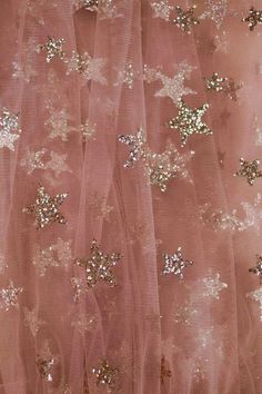 a pink dress with gold stars on it