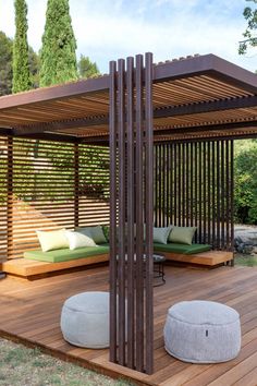 a large wooden gazebo sitting on top of a wooden deck