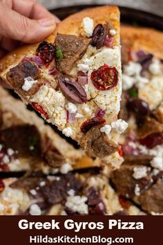 a slice of greek gyro pizza with feta cheese and olives on top