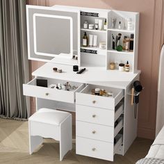 a white dressing table with drawers, mirror and stool