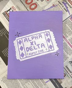 a purple piece of paper with the words aloha xi delta painted on it