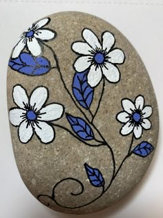 a rock with flowers painted on it