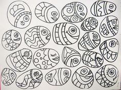 an image of fish drawn in black and white on paper with colored pencils to the side