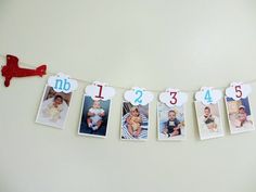 a garland with photos hanging from it's sides and the number one on each side